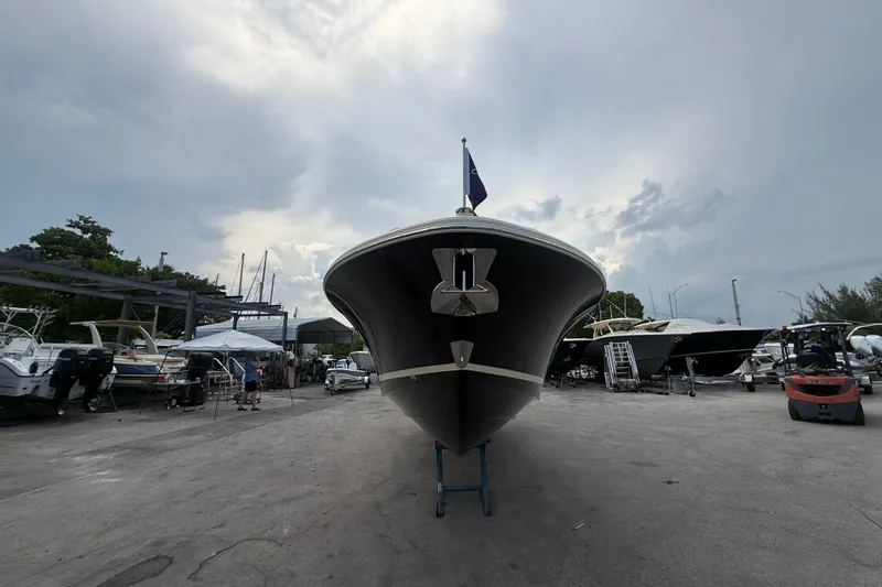 Slide: The Image of 2027 Chris-Craft Sportster 28 OB boat on display in a marina setting. - 30