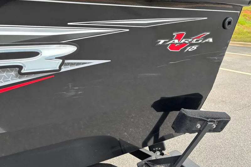 Slide: The Image of 2024 Tracker Targa 18 WT boat with sleek black exterior and logo detailing. - 13