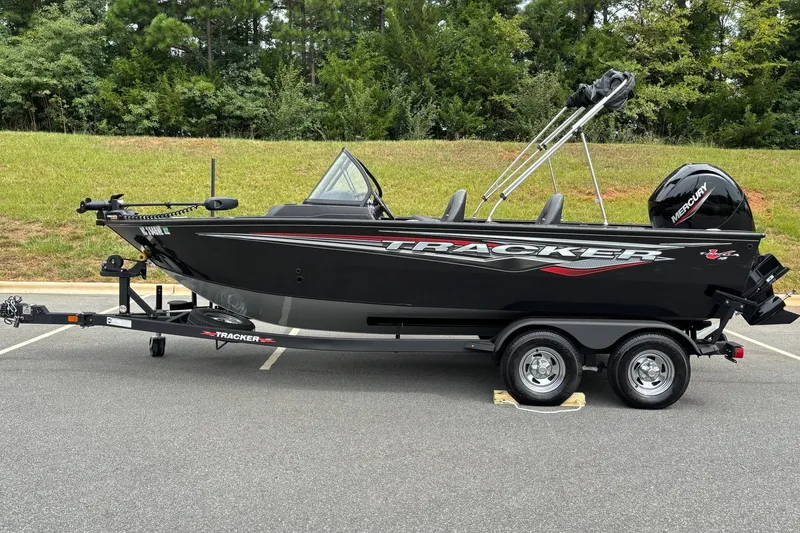 The Image of 2024 Tracker Targa 18 WT boat on trailer, parked outdoors, side view. - 0