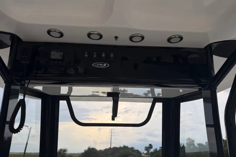 Slide: The Image of 2022 Sea Hunt Ultra 275SE boat interior with control panel and overhead lighting. - 25