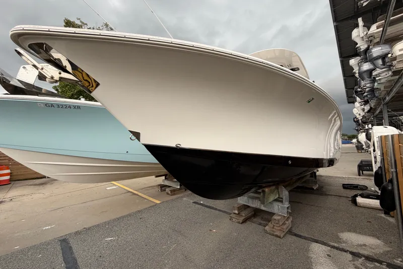 Slide: The Image of 2022 Sea Hunt Ultra 275SE boat on display at a marina. - 27
