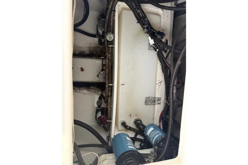 Slide: The Image of Engine compartment of 2022 Sea Hunt Ultra 275SE boat with visible wiring and components. - 21