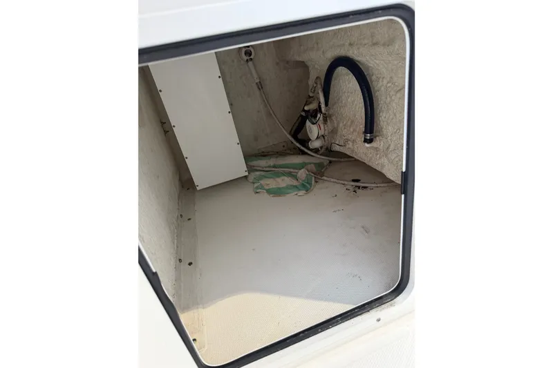 Slide: The Image of Storage compartment of 2022 Sea Hunt Ultra 275SE boat, showing interior details. - 9
