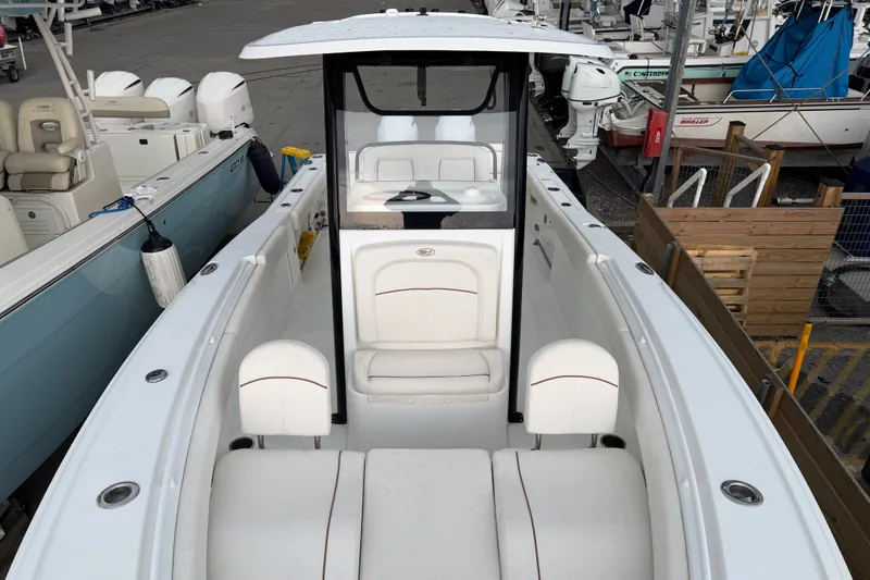Slide: The Image of 2022 Sea Hunt Ultra 275SE boat interior with white seating and console. - 19