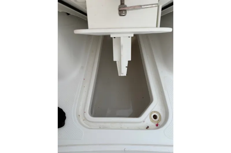 Slide: The Image of 2022 Sea Hunt Ultra 275SE boat storage compartment, white interior, close-up view. - 13