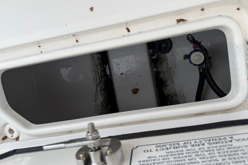 Slide: The Image of Compartment view inside 2022 Sea Hunt Ultra 275SE boat, showing wiring and components. - 22