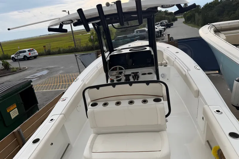 Slide: The Image of 2022 Sea Hunt Ultra 275SE boat with spacious seating and modern controls. - 28