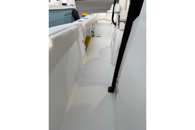 Slide: The Image of 2022 Sea Hunt Ultra 275SE boat interior with white seating and sleek design. - 11