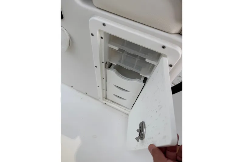Slide: The Image of Storage compartment on a 2022 Sea Hunt Ultra 275SE boat, featuring an open hatch. - 10