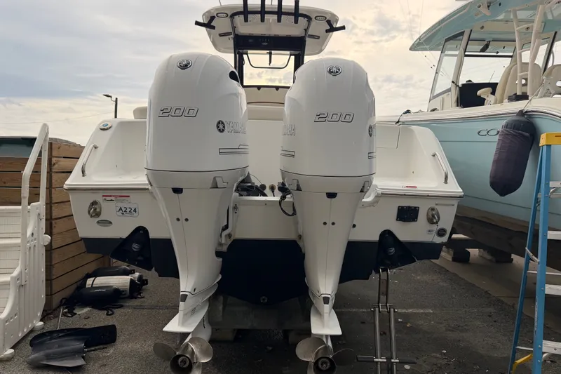 Slide: The Image of 2022 Sea Hunt Ultra 275SE boat with twin Yamaha 200 engines, docked outdoors. - 30