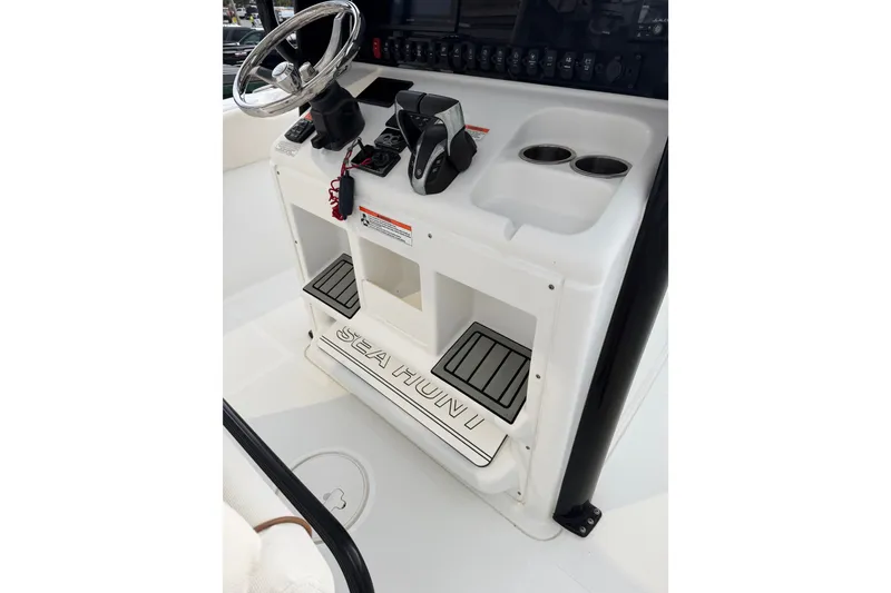Slide: The Image of 2022 Sea Hunt Ultra 275SE boat console with steering wheel and controls. - 4