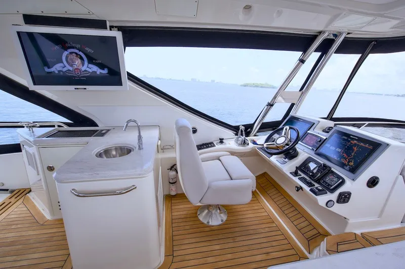 Slide: The Image of Luxurious 2017 Sea Ray L590 Fly yacht helm with modern controls and panoramic view. - 34