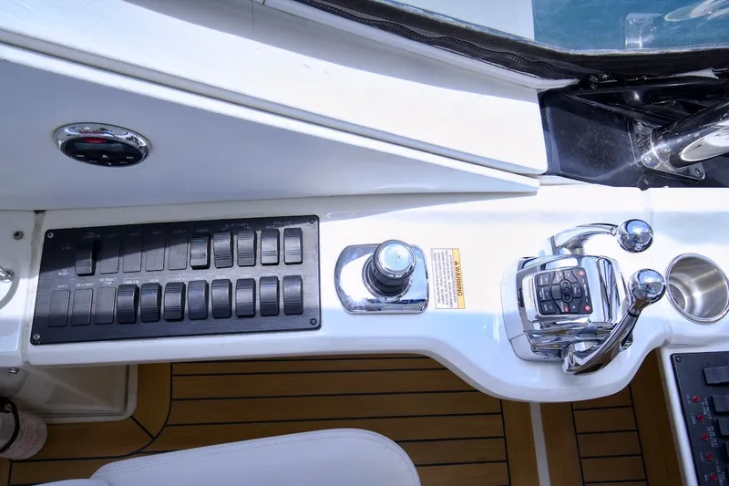 Slide: The Image of Control panel of a 2017 Sea Ray L590 Fly yacht with switches and throttle levers. - 37