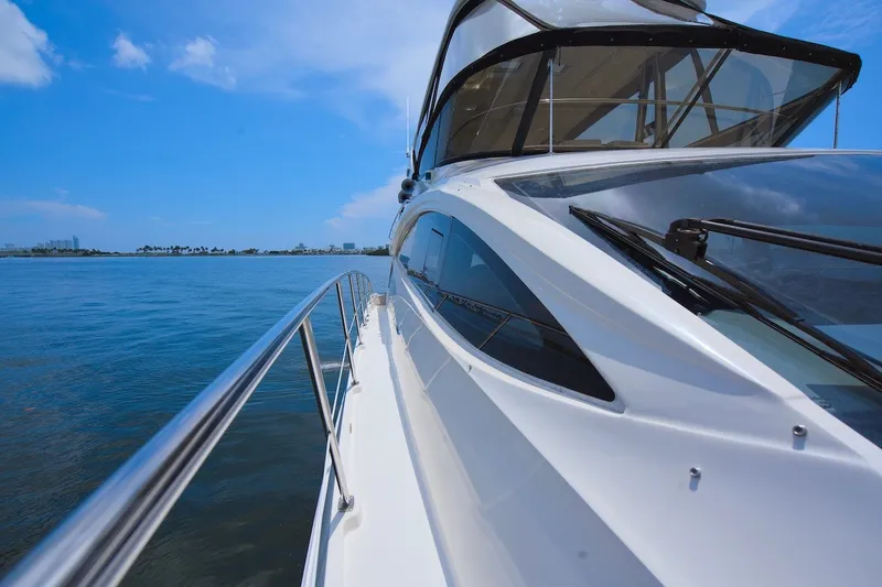 Slide: The Image of 2017 Sea Ray L590 Fly yacht cruising on calm blue waters under a clear sky. - 30