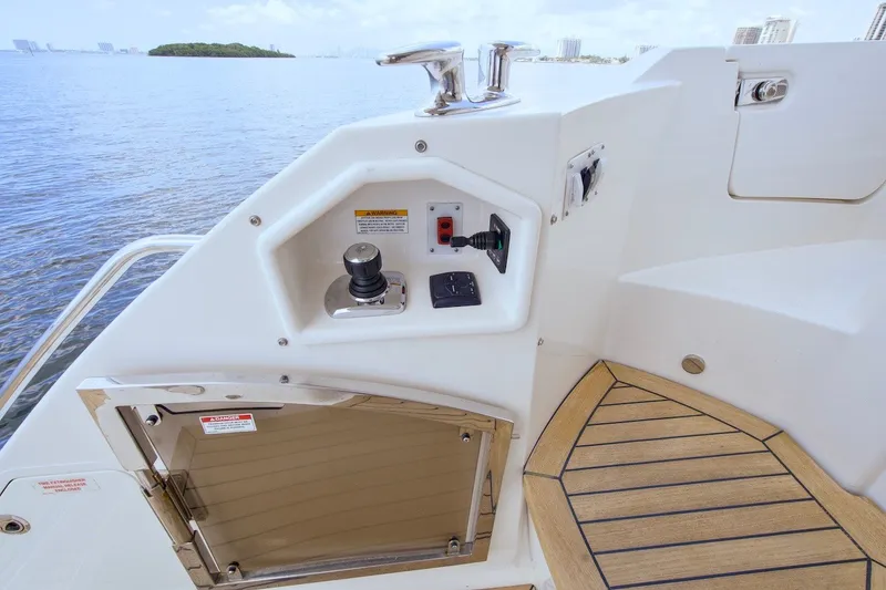 Slide: The Image of 2017 Sea Ray L590 Fly yacht control panel with joystick and scenic water view. - 31