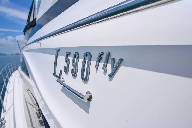 Slide: The Image of 2017 Sea Ray L590 Fly yacht side view with model nameplate. - 25