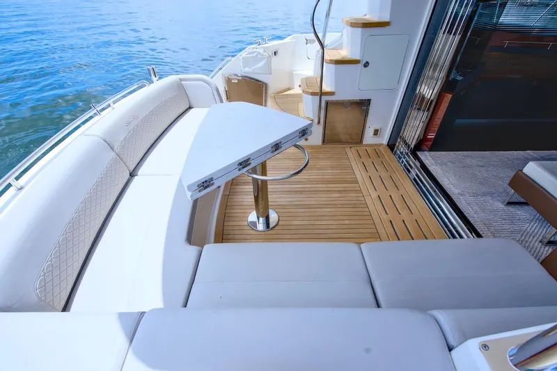 Slide: The Image of Luxurious 2017 Sea Ray L590 Fly yacht deck with elegant seating and table. - 23