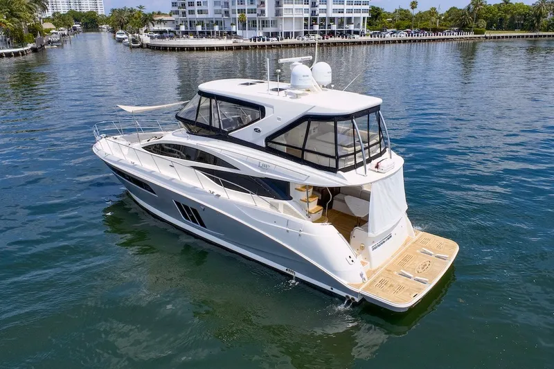 Slide: The Image of 2017 Sea Ray L590 Fly yacht cruising in a scenic waterfront setting. - 18