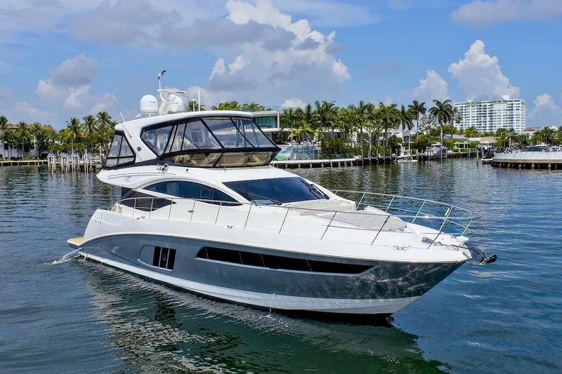 Slide: The Image of 2017 Sea Ray L590 Fly yacht cruising in a scenic waterfront setting. - 4