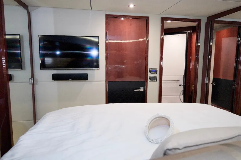 Slide: The Image of Luxurious bedroom interior of 2017 Sea Ray L590 Fly yacht with TV and elegant decor. - 59