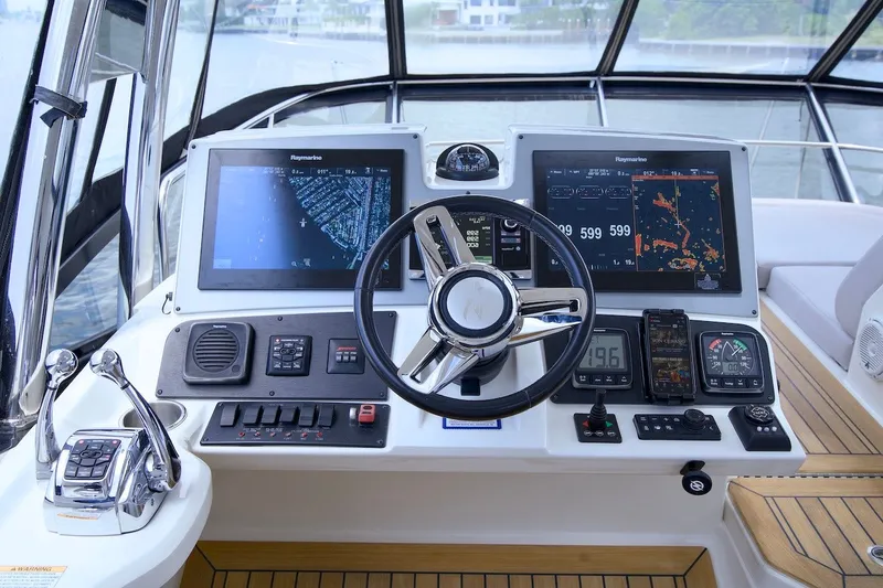 Slide: The Image of Cockpit of 2017 Sea Ray L590 Fly yacht with advanced navigation systems and controls. - 36