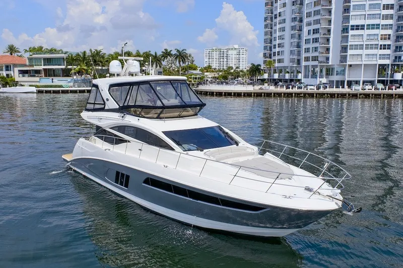 Slide: The Image of 2017 Sea Ray L590 Fly yacht cruising near waterfront buildings. - 12