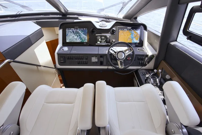 Slide: The Image of Helm of 2017 Sea Ray L590 Fly yacht with dual navigation screens and leather seating. - 50