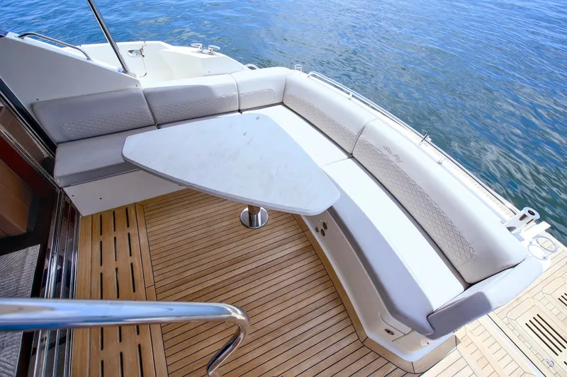 Slide: The Image of Luxurious seating area on 2017 Sea Ray L590 Fly yacht with elegant table and wood flooring. - 21