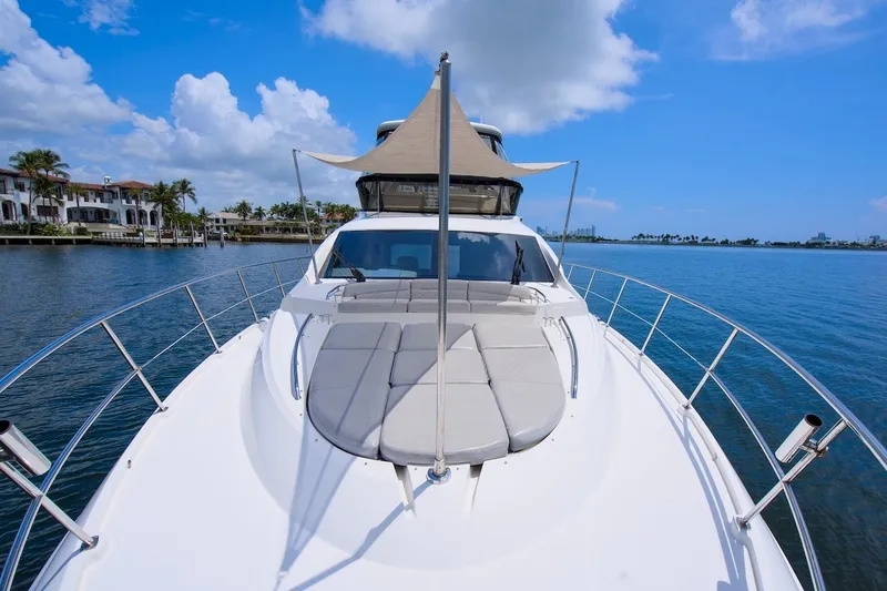 Slide: The Image of 2017 Sea Ray L590 Fly yacht on calm waters, featuring spacious deck and luxurious design. - 26