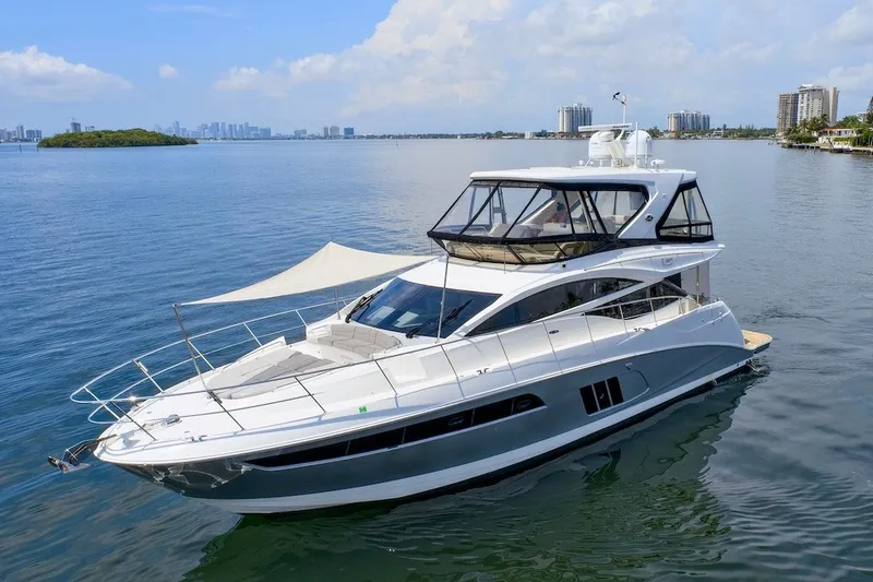 Slide: The Image of Luxurious 2017 Sea Ray L590 Fly yacht cruising on calm waters under a clear sky. - 16