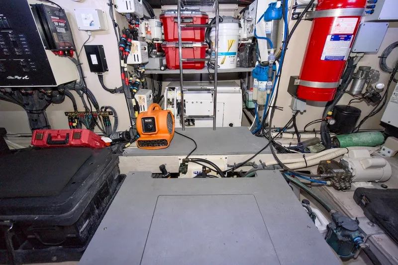 Slide: The Image of Engine room of 2017 Sea Ray L590 Fly yacht, featuring equipment and safety gear. - 68
