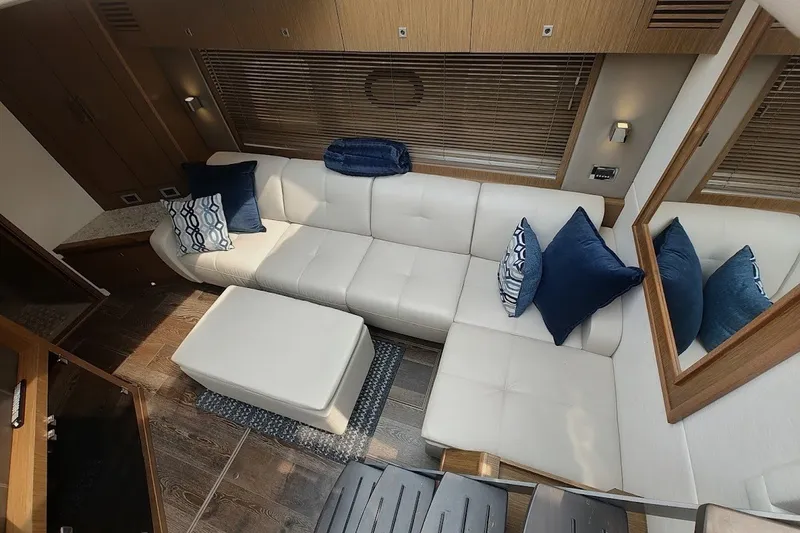 Slide: The Image of Luxurious interior of 2017 Sea Ray Sundancer 510 yacht with white leather seating and blue cushions. - 27