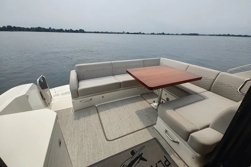 Slide: The Image of Luxurious 2017 Sea Ray Sundancer 510 yacht with spacious outdoor seating and scenic water view. - 14