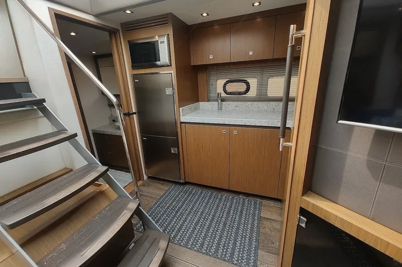 Slide: The Image of Luxurious interior of 2017 Sea Ray Sundancer 510 yacht with modern kitchen and staircase. - 26