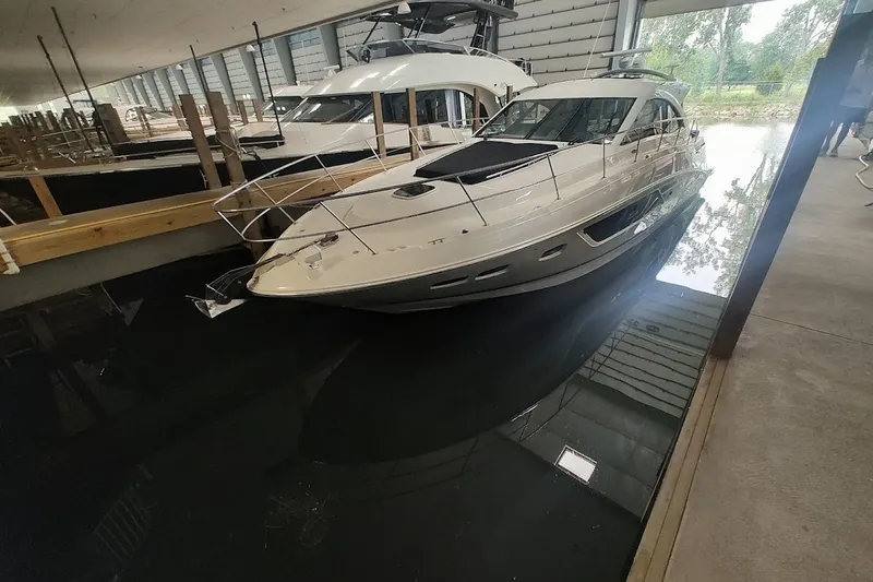 Slide: The Image of 2017 Sea Ray Sundancer 510 yacht docked indoors, reflecting on calm water. - 6