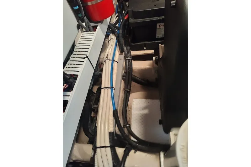 Slide: The Image of Engine compartment of a 2017 Sea Ray Sundancer 510 with visible wiring and components. - 47
