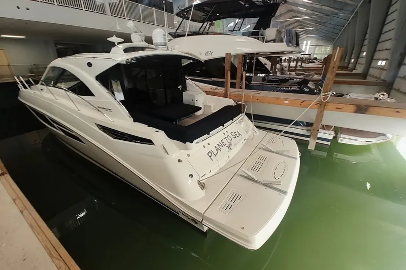 Slide: The Image of 2017 Sea Ray Sundancer 510 yacht docked indoors, showcasing sleek design and luxury features. - 7
