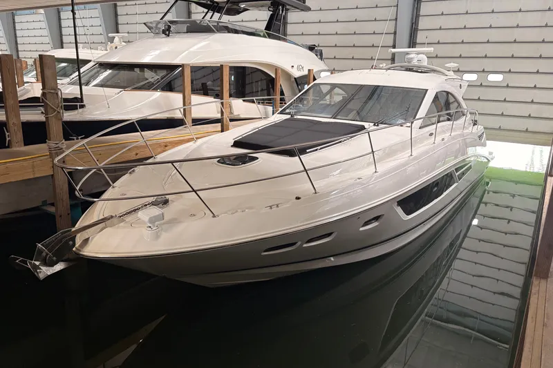 Slide: The Image of 2017 Sea Ray Sundancer 510 yacht docked indoors, showcasing sleek design and luxury features. - 41