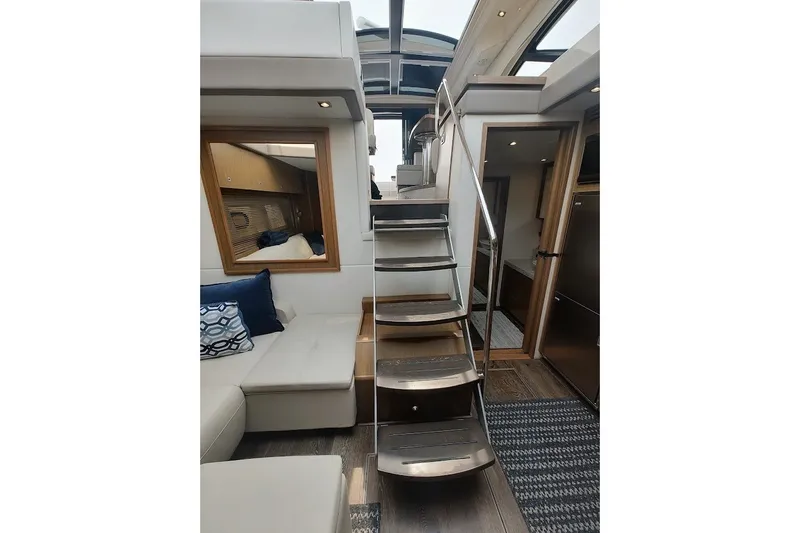Slide: The Image of Interior of 2017 Sea Ray Sundancer 510 yacht with modern staircase and seating area. - 17