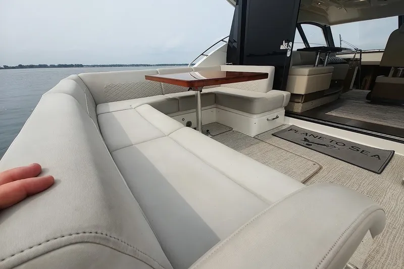 Slide: The Image of Luxurious 2017 Sea Ray Sundancer 510 yacht interior with plush seating and elegant table. - 15