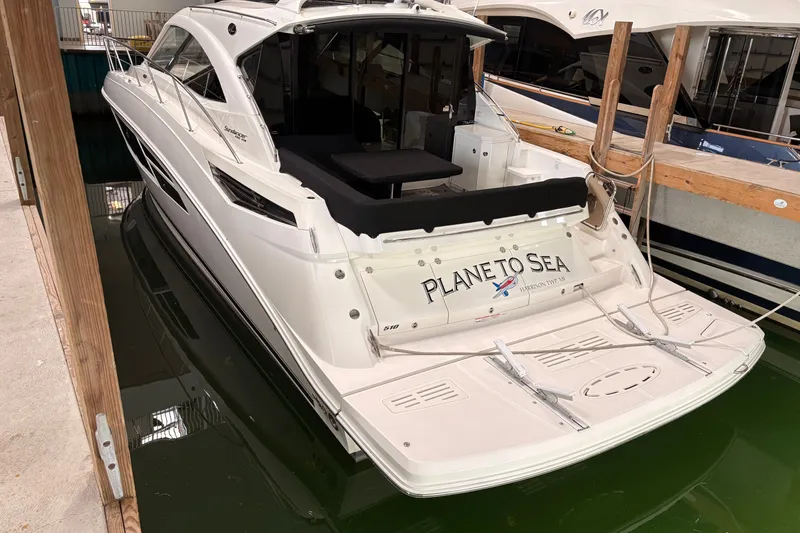 Slide: The Image of 2017 Sea Ray Sundancer 510 yacht docked, rear view with "Plane to Sea" name visible. - 9