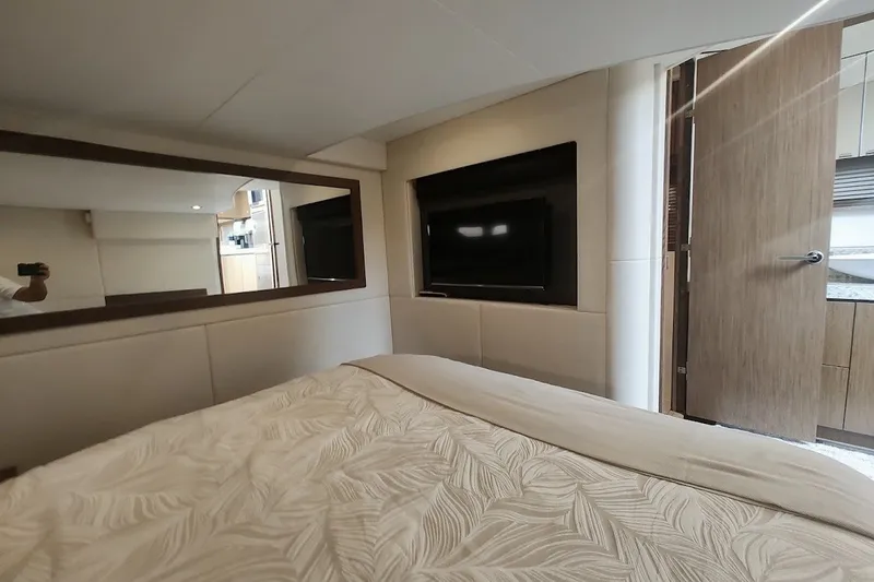 Slide: The Image of Luxurious interior of 2017 Sea Ray Sundancer 510 yacht bedroom with TV and mirror. - 34