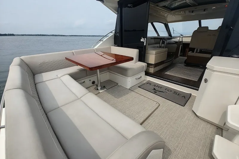 Slide: The Image of Luxurious 2017 Sea Ray Sundancer 510 yacht interior with elegant seating and wooden table. - 12