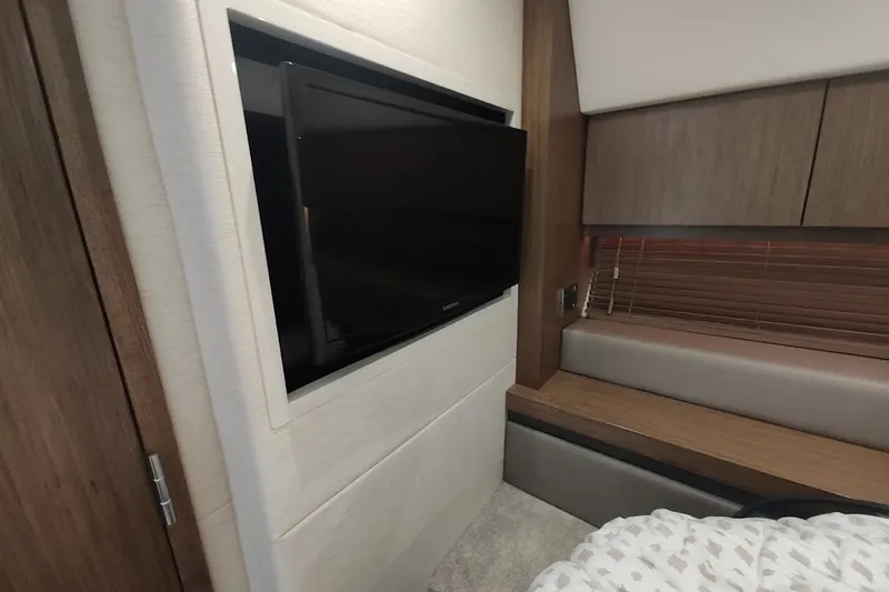 Slide: The Image of Interior of 2017 Sea Ray Sundancer 510 yacht with wall-mounted TV and wooden cabinetry. - 29