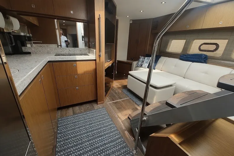 Slide: The Image of Interior of 2017 Sea Ray Sundancer 510 yacht with modern kitchen and cozy seating area. - 30