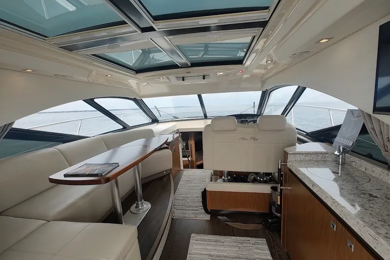 Slide: The Image of Luxurious interior of 2017 Sea Ray Sundancer 510 yacht with panoramic windows and elegant seating. - 18