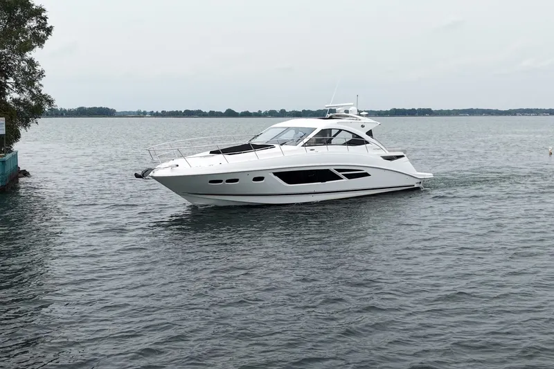 The Image of 2017 Sea Ray Sundancer 510 yacht cruising on a calm lake. - 0