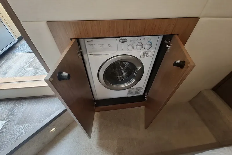 Slide: The Image of Built-in washing machine on 2017 Sea Ray Sundancer 510 yacht, behind wooden cabinet doors. - 35