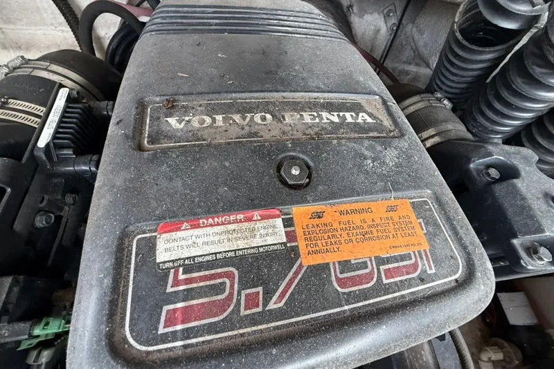 Slide: The Image of Volvo Penta engine in a 2001 Chaparral 230 SSi boat, showing warning labels. - 17