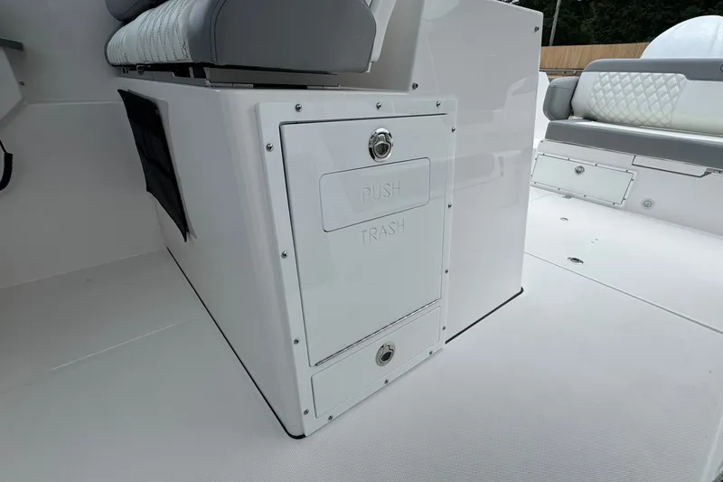 Slide: The Image of Edgewater 310SC 2027 boat interior with integrated trash compartment and seating. - 35
